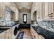 Laundry room featuring designer wallpaper, front loading washer and dryer, granite countertops, and custom cabinets at 290 Ardsley Ln, Alpharetta, GA 30005
