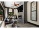 Elegant living room with a fireplace, dark trim, stone flooring, and gray accent wall for modern sophistication at 290 Ardsley Ln, Alpharetta, GA 30005