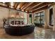 Warm and inviting living room with a stone fireplace, beamed ceiling, and ample seating, perfect for relaxing and entertaining at 290 Ardsley Ln, Alpharetta, GA 30005