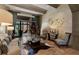 Inviting living room with stone floors, a cowhide rug, and sliding glass doors at 290 Ardsley Ln, Alpharetta, GA 30005