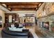 Cozy living room featuring a stone fireplace, wet bar, and open access to the dining area, perfect for entertaining guests at 290 Ardsley Ln, Alpharetta, GA 30005