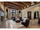 Beautiful living room with exposed beams, stone fireplace, and large windows, creating a bright and inviting atmosphere at 290 Ardsley Ln, Alpharetta, GA 30005