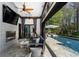 Open-air living room transitions seamlessly to an outdoor pool area for exquisite indoor-outdoor living at 290 Ardsley Ln, Alpharetta, GA 30005