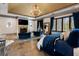 Spacious main bedroom featuring a fireplace, a television, and blue accents at 290 Ardsley Ln, Alpharetta, GA 30005