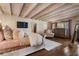 Comfortable main bedroom featuring a wood beamed ceiling, wood floors, and a large window view at 290 Ardsley Ln, Alpharetta, GA 30005