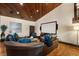 Inviting media room with a large screen, surround sound, hardwood floors and a stunning wood plank ceiling at 290 Ardsley Ln, Alpharetta, GA 30005
