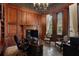 Sophisticated office with dark wood paneling, a fireplace, and built-in bookshelves at 290 Ardsley Ln, Alpharetta, GA 30005