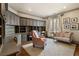 Home office with custom built-in cabinetry, a comfortable chair, and natural light at 290 Ardsley Ln, Alpharetta, GA 30005