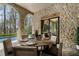 Covered patio with stone walls, outdoor dining table, and a view of the pool at 290 Ardsley Ln, Alpharetta, GA 30005