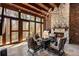 Inviting outdoor patio with stone fireplace, grill, and comfortable seating, perfect for entertaining and enjoying the natural surroundings at 290 Ardsley Ln, Alpharetta, GA 30005