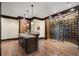 Custom wine cellar with extensive storage, wood trim, and an island with granite countertop with barstool seating at 290 Ardsley Ln, Alpharetta, GA 30005