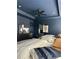 Stylish blue bedroom with king size bed, dark furniture, and modern art at 4836 Se Merriman Se Walk # 23, Smyrna, GA 30080