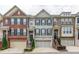 Charming townhomes featuring brick and stone facades, garage parking, and welcoming front entrances at 4836 Se Merriman Se Walk # 23, Smyrna, GA 30080