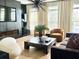 Modern living room with hardwood floors, large windows, and stylish furniture at 4836 Se Merriman Se Walk # 23, Smyrna, GA 30080
