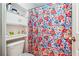 Cozy bathroom featuring a floral shower curtain and built-in shelving for storage at 3560 Glen Summit Ln, Snellville, GA 30039