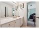 Well-lit bathroom with a vanity sink and mirror, adjacent to a bedroom at 3560 Glen Summit Ln, Snellville, GA 30039