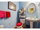 Charming bathroom featuring a pedestal sink, framed mirror, and decorative elements at 3560 Glen Summit Ln, Snellville, GA 30039