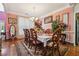 Elegant dining room boasts a chandelier, ornate chairs, and a large window for natural light at 3560 Glen Summit Ln, Snellville, GA 30039