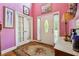 Inviting foyer features a beautiful front door, sidelights, and decorative rug on hardwood flooring at 3560 Glen Summit Ln, Snellville, GA 30039
