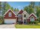Charming two-story brick home featuring a well-manicured lawn and attached two-car garage at 3560 Glen Summit Ln, Snellville, GA 30039