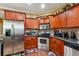 Modern kitchen features stainless steel appliances and ample wood cabinetry at 3560 Glen Summit Ln, Snellville, GA 30039