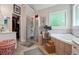 Relaxing main bathroom featuring a glass shower, soaking tub, and ample counter space at 3560 Glen Summit Ln, Snellville, GA 30039
