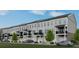 New townhouse exteriors boast neutral siding, private balconies, and attached garages with green space at 538 Sawnee Village Blvd # D67, Cumming, GA 30040