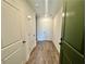 Hallway with wood floors and white doors at 538 Sawnee Village Blvd # D67, Cumming, GA 30040
