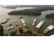 Scenic aerial view of the waterfront featuring lush green trees and docks with boat slips at 556 Sawnee Village Blvd # D76, Cumming, GA 30040