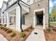 Inviting entryway featuring a covered porch, well-maintained landscaping, and a modern design at 556 Sawnee Village Blvd # D76, Cumming, GA 30040