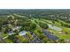 This aerial view shows a golf course, a lake, and swimming pool in a beautiful community at 6730 Waterbury Way, Cumming, GA 30040
