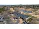 This aerial view showcases the golf course, pond and community center at 6730 Waterbury Way, Cumming, GA 30040