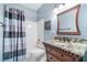 Cozy bathroom features a vanity with a granite countertop and a shower with a shower curtain at 6730 Waterbury Way, Cumming, GA 30040