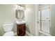 Bathroom with a pedestal sink and a glass-enclosed shower providing a simple and clean design at 6730 Waterbury Way, Cumming, GA 30040