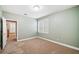 Bedroom showcasing neutral paint and shuttered windows, creating a bright and serene space at 6730 Waterbury Way, Cumming, GA 30040