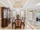 Formal dining room featuring a chandelier, wainscoting, trey ceiling and tile floor at 6730 Waterbury Way, Cumming, GA 30040