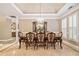 Formal dining room featuring a chandelier, wainscoting, trey ceiling and tile floor at 6730 Waterbury Way, Cumming, GA 30040