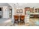 Open kitchen with breakfast bar, stainless steel appliances, and views into the dining area at 6730 Waterbury Way, Cumming, GA 30040