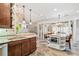 Eat-in kitchen with a kitchen island featuring pendant lights and a view to the living room at 6730 Waterbury Way, Cumming, GA 30040