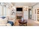 Cozy living room featuring stone fireplace, recessed lighting, and built-in bookshelves at 6730 Waterbury Way, Cumming, GA 30040