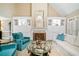 Cozy living room featuring a stylish fireplace, built-in shelving, and comfortable seating arrangement at 6730 Waterbury Way, Cumming, GA 30040