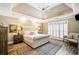 Bright and airy main bedroom with tray ceilings, plantation shutters, and hardwood floors at 6730 Waterbury Way, Cumming, GA 30040