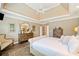 Bright main bedroom featuring tray ceilings, recessed lighting, and sitting area at 6730 Waterbury Way, Cumming, GA 30040