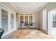 Relaxing sunroom with stone floors, a ceiling fan, and plenty of natural light at 6730 Waterbury Way, Cumming, GA 30040