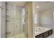 Bathroom with glass shower, tile surround and a luxurious soaking tub at 806 Jefferson Sw Ct, Conyers, GA 30094
