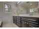 Bathroom featuring dual sinks, dark wood cabinets, and tile flooring at 806 Jefferson Sw Ct, Conyers, GA 30094