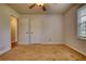 Bright bedroom features neutral carpeting and a ceiling fan, offering a cozy and inviting space at 806 Jefferson Sw Ct, Conyers, GA 30094