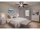Comfortable bedroom featuring a ceiling fan, dresser, and natural light from the windows at 806 Jefferson Sw Ct, Conyers, GA 30094