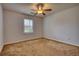 Cozy bedroom with a ceiling fan, window with blinds, and ample space at 806 Jefferson Sw Ct, Conyers, GA 30094
