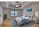 Spacious bedroom featuring a ceiling fan, natural light from a window, and stylish decor at 806 Jefferson Sw Ct, Conyers, GA 30094